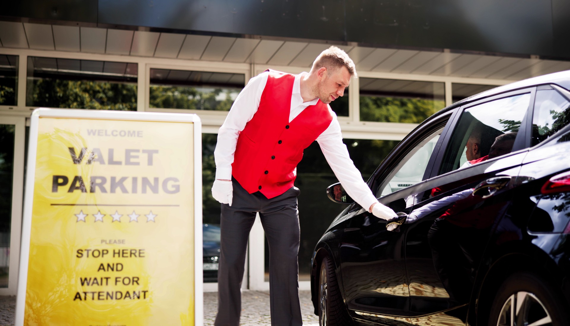 Personalized Luxury Valet Service: A Young Businessman Receives Receipt